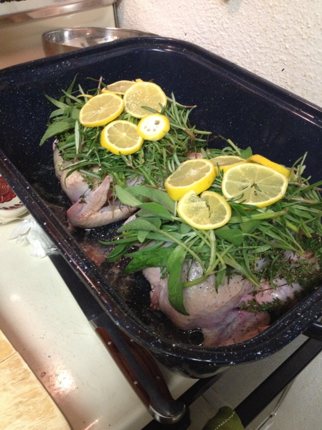 Two organic chickens piled high with herbs and stuff.