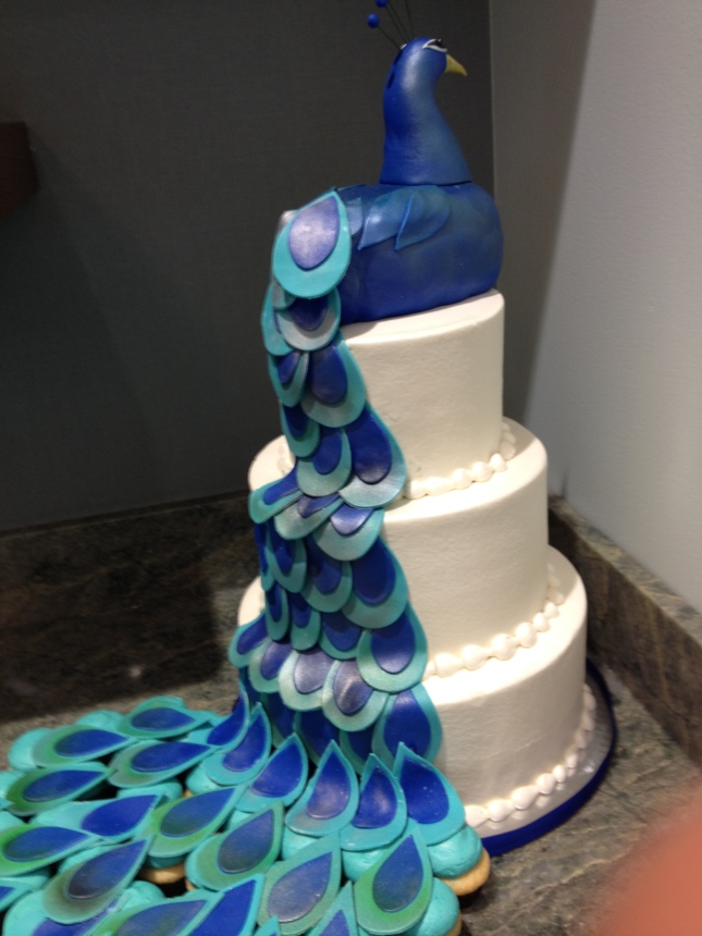 The cake, with a cake peacock on top. 